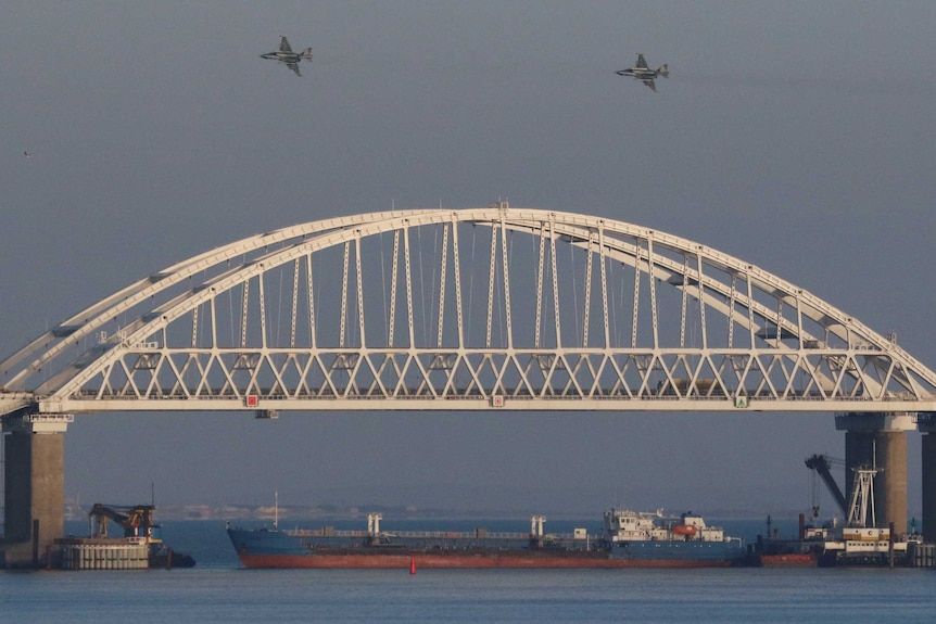 Russian jet fighters fly over a bridge connecting the Russian mainland with the Crimean Peninsula.