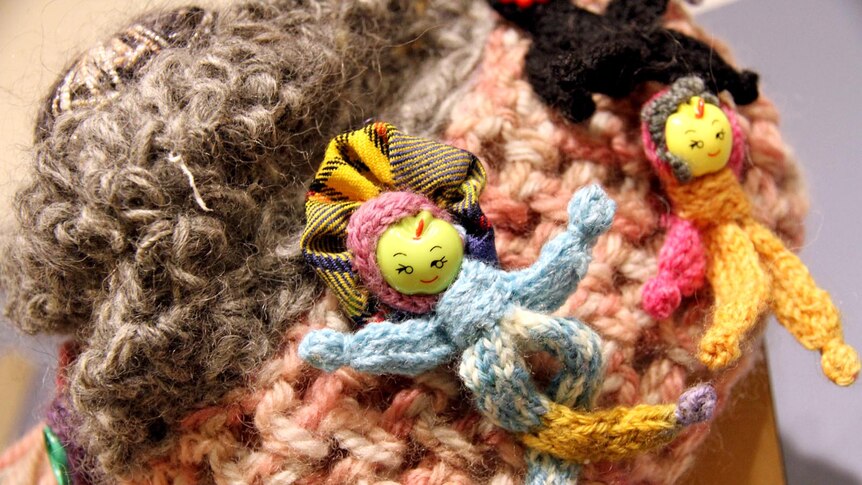 Figurines decorate one of the beanies.