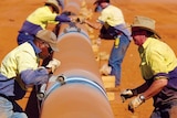 People constructing a pipeline