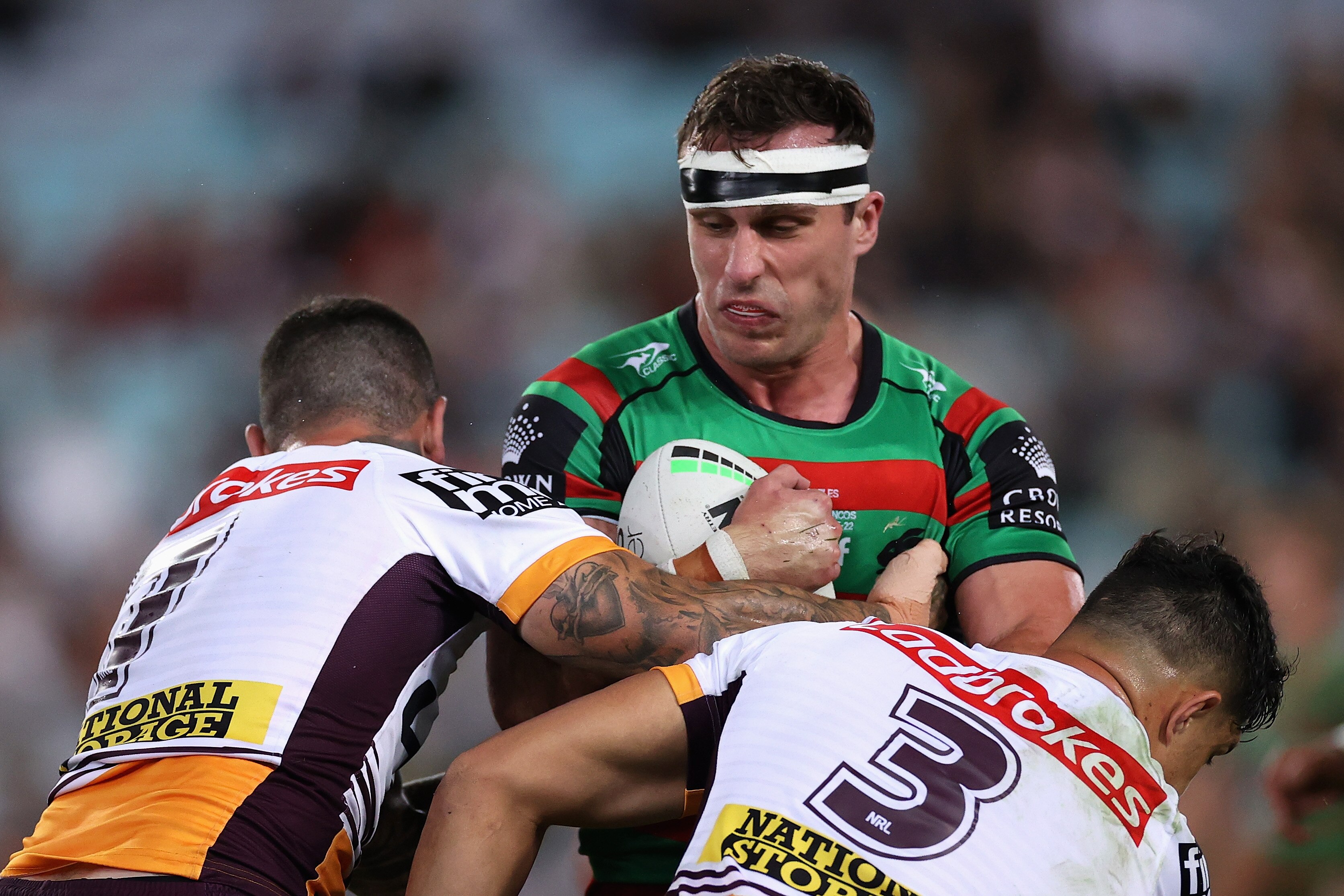 A man runs the ball during a rugby league match
