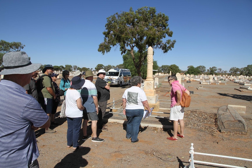 People and a bus at the Broken Hill cemetery.