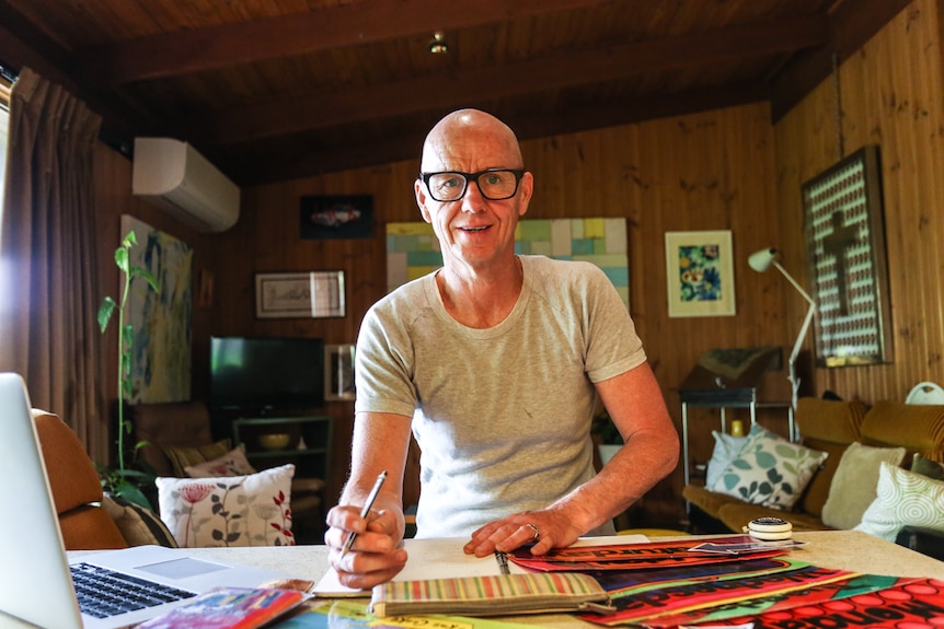 Teacher Peter O'Mara at home at his desk.