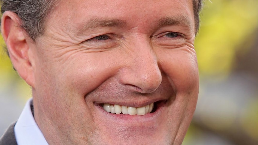 Piers Morgan smiles for photographers
