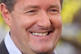 Piers Morgan smiles for photographers