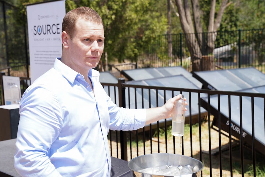 Zero Mass Water's James Symons pulls water bottle out of ice bowl