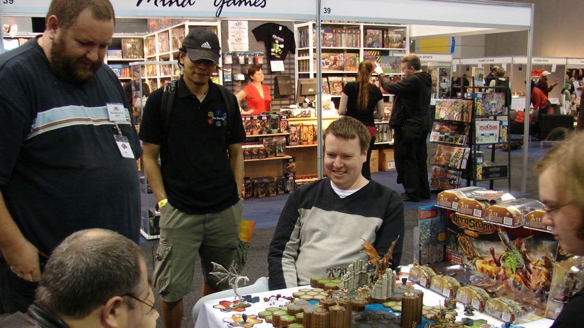 Group of people playing one of the new board games at the biggest gaming convention in Australia