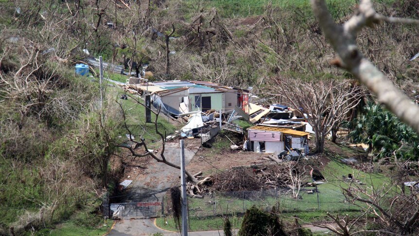 Debris surrounds a damaged home in Vieques.