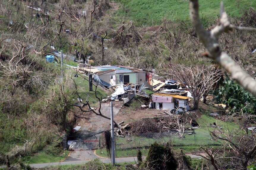 Debris surrounds a damaged home in Vieques.