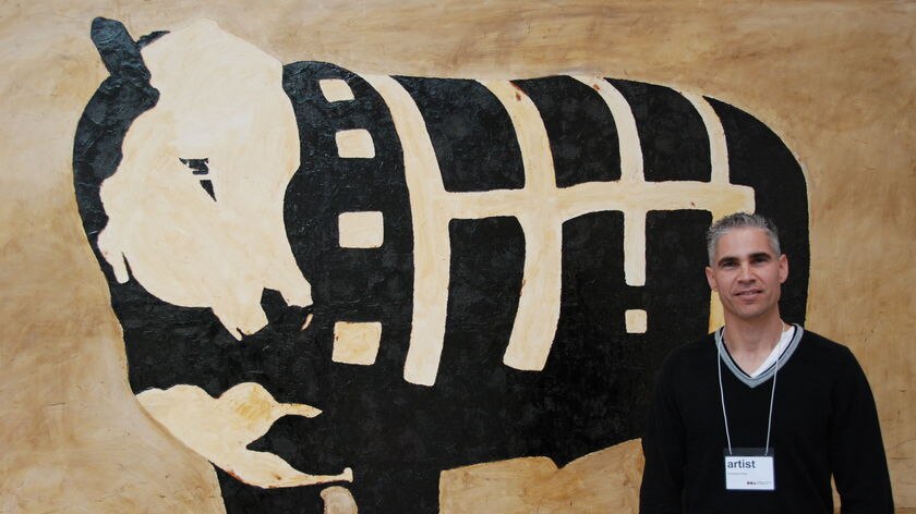 Great honour: Christopher Pease with his painting 'Cow with body paint'.