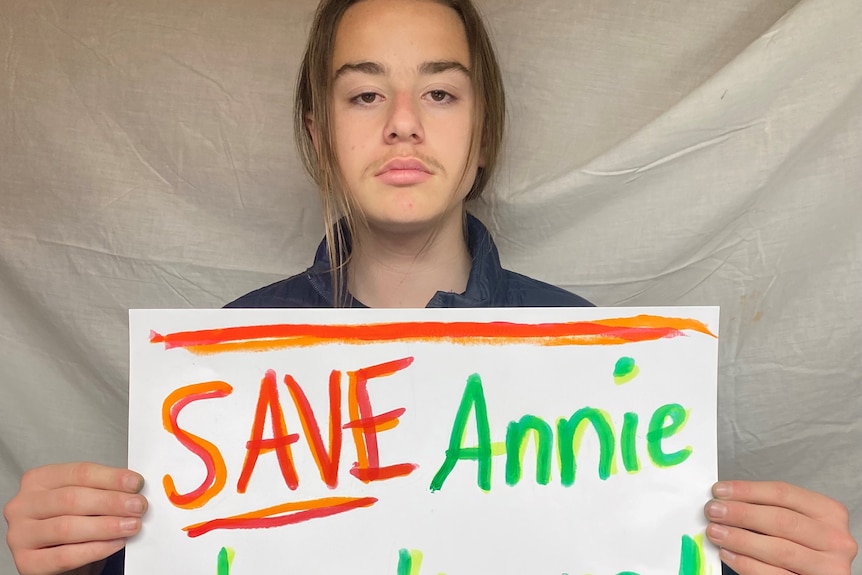 Whyalla Youth Group member Benjamin Spigiel holds his sign up 'Save Annie Lockwood'.