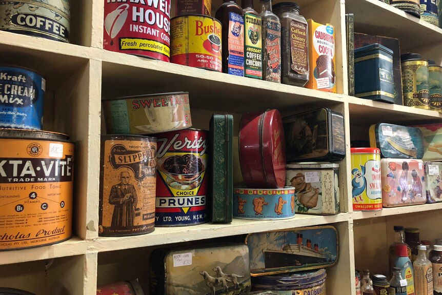 photo of old cans and tins in a collector's store 