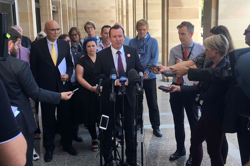 WA Premier Mark McGowan outside Parliament House with journalists and child sex abuse survivors.