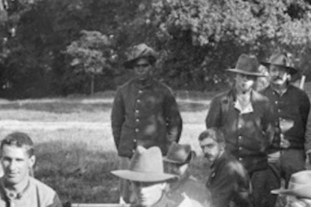 William Williams stands in uniform among a group of hospital patients