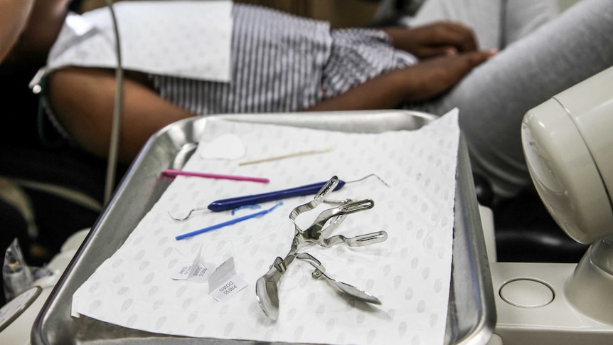 Dental equipment sitting on a tray.