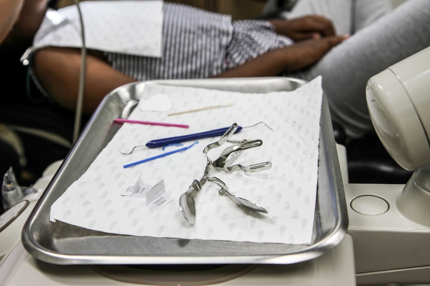 Dental equipment sitting on a tray.