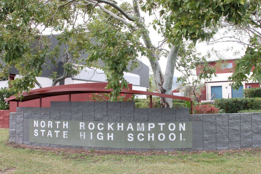 Exterior of a school wall with the sign North Rockhampton State High School.