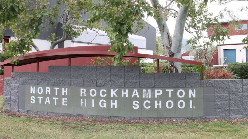 Exterior of a school wall with the sign North Rockhampton State High School.