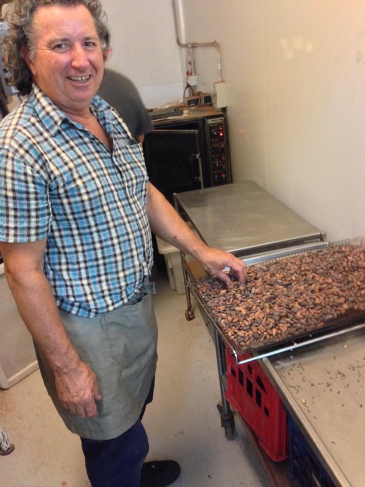 Gold Coast chocolate maker Peter Mengler with a tray of cacao beans