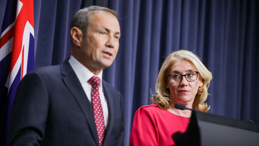 Rita Saffioti looks at Roger Cook as he speaks at a press conference