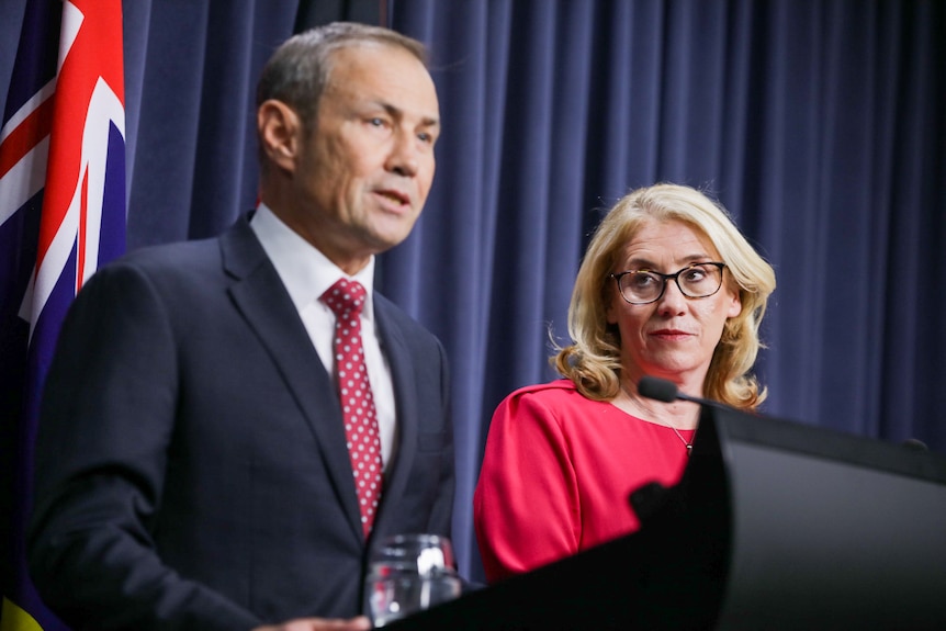 Rita Saffioti looks at Roger Cook as he speaks at a press conference
