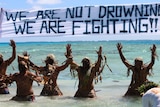 Tokelauns perform a warrior dance to promote action against climate change