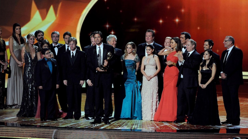 The cast and crew of Modern Family accept the Outstanding Comedy Series award onstage at the Emmys