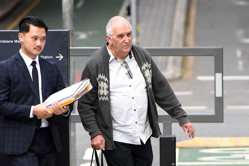 Former Brisbane teacher Peter Matthew Malone (right) arrives at the District Court in Brisbane.