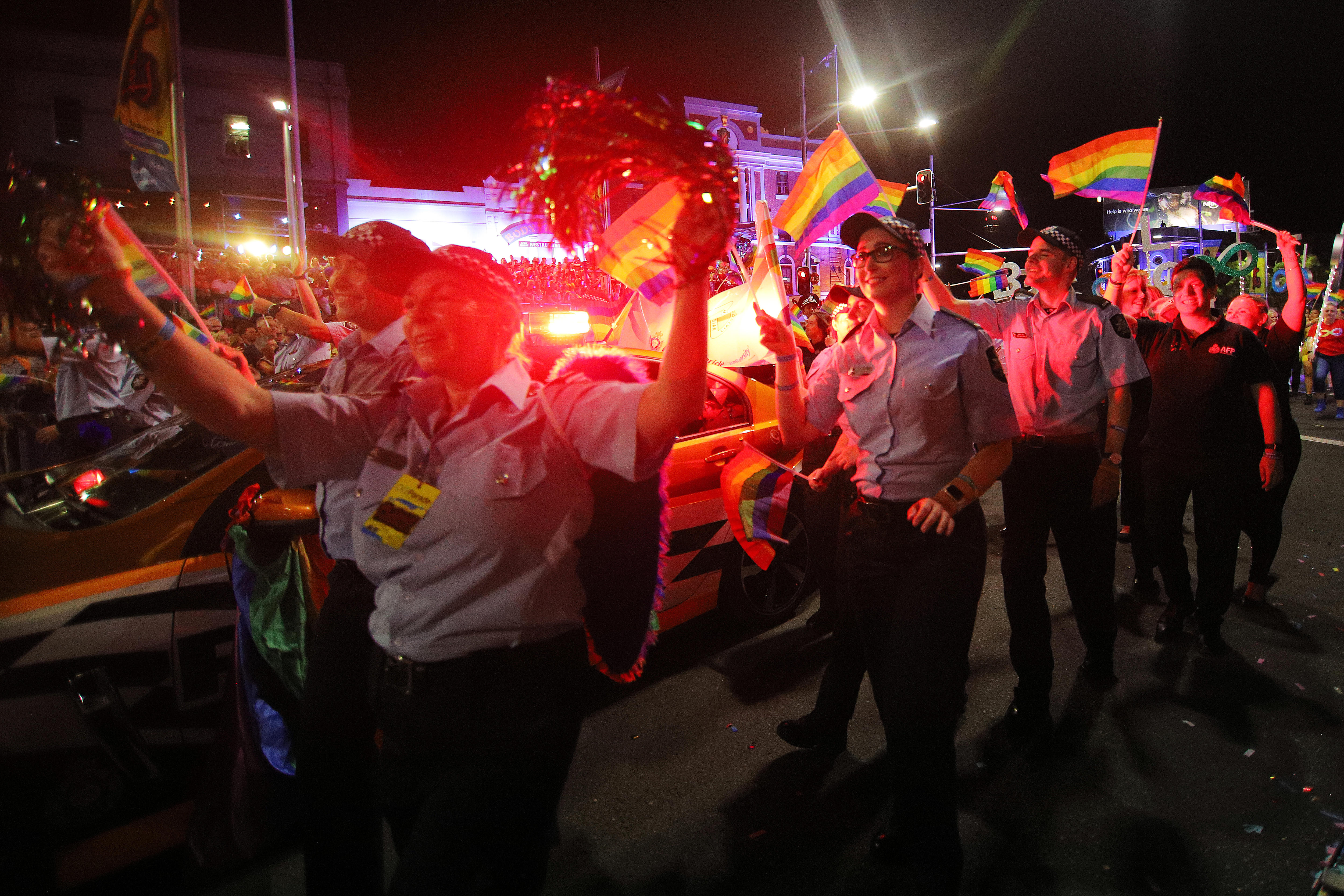 Police officers carry rainbow flags as they march at the sydney mardi gras parade in 2019