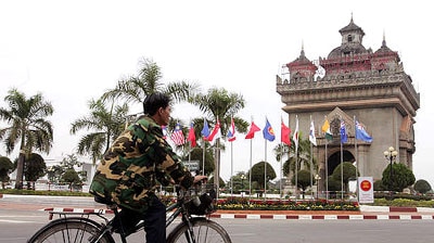Man rides past flags of ASEAN nations.