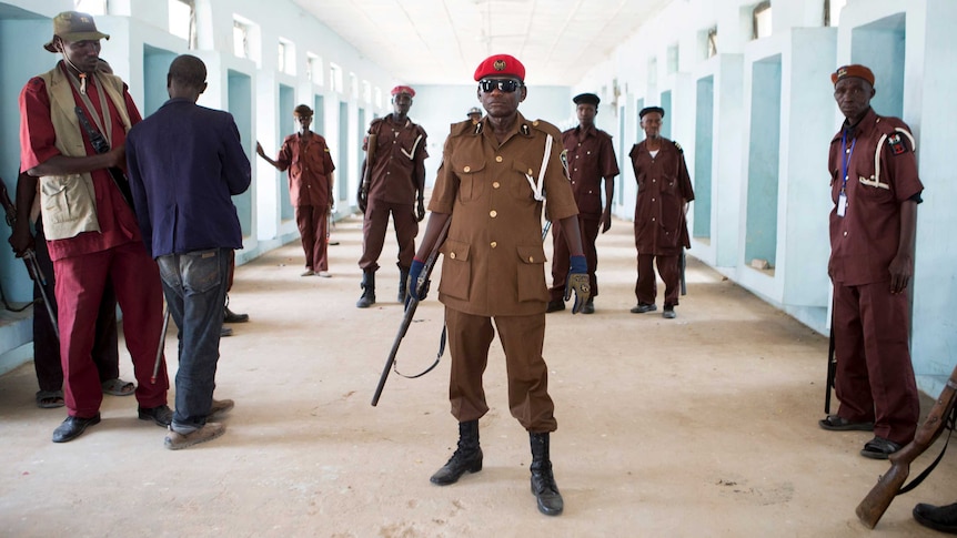 Members of a vigilante group of traditional hunters pose for a picture at their camp in Nigeria.