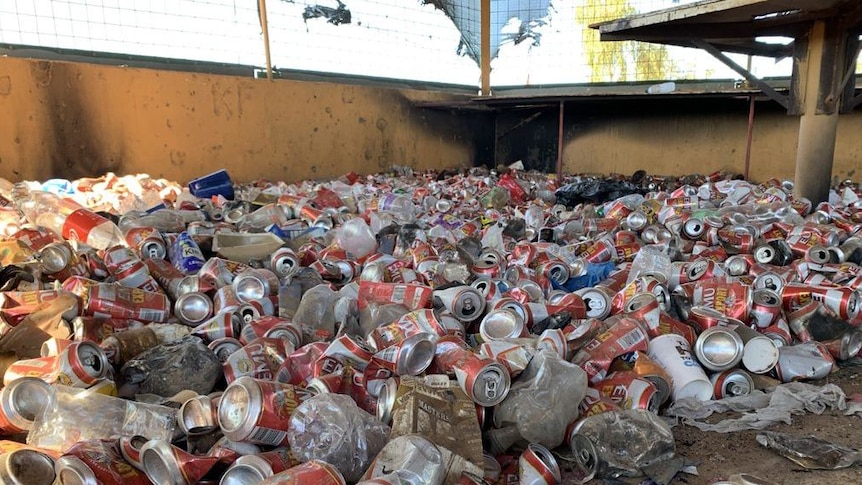 Image of empty cans of alcohol littering the ground under a public area in Fitzroy Crossing in Western Australia.