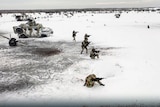 In the snow, Russian soldiers perform drills in an unspecified location in Belarus