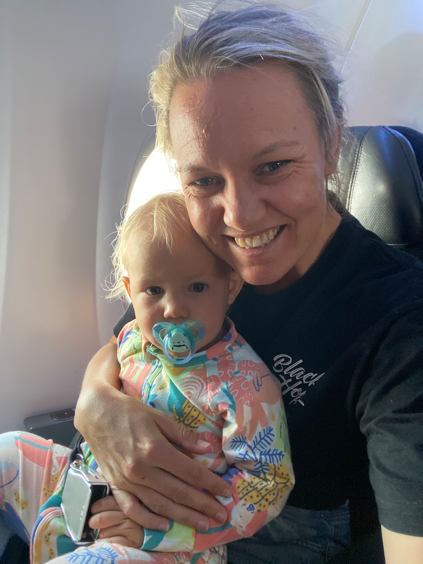 Amy Hetherington with daughter Ruby on a plane