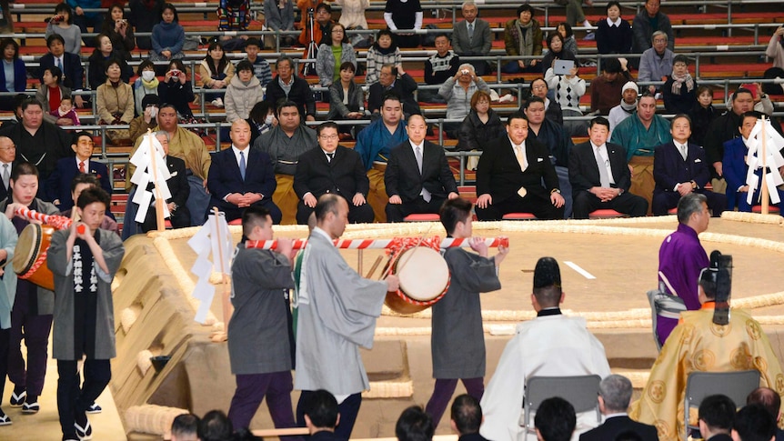 Sumo chief Nobuyoshi Hakkaku watches a ceremony to purify the Sumo ring