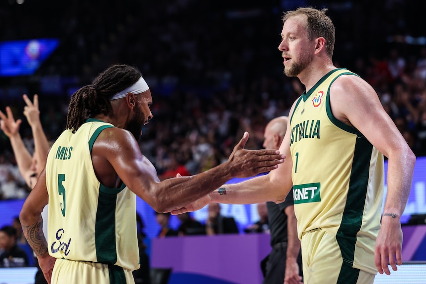 Australia Boomers Patty Mills and Joe Ingles high five during a game at the FIBA World Cup.