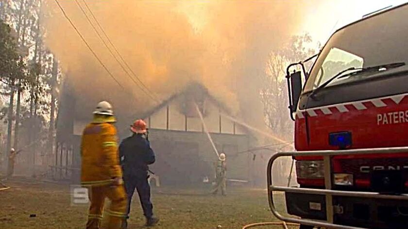 Firefighters battle a blaze that destroyed a house at Salt Ash in the Port Stephens region yesterday.