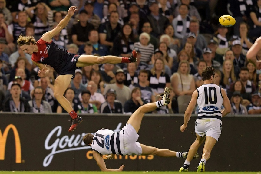 Jordan Murdoch (R) of the Cats and Jayden Hunt of the Demons collide after contesting for mark.