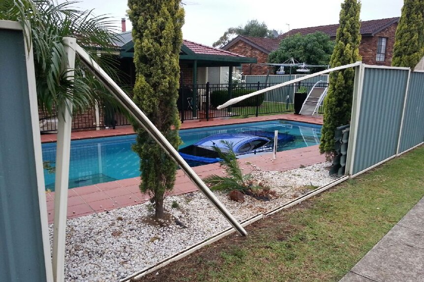car in backyard pool
