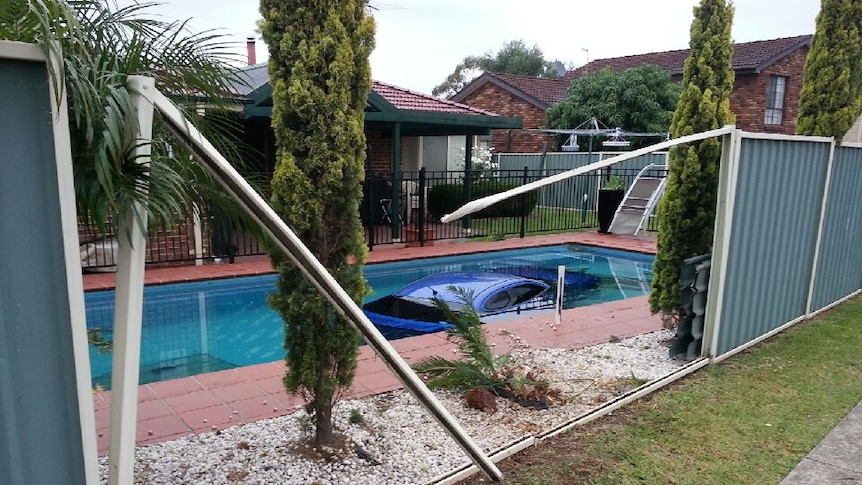 car in backyard pool