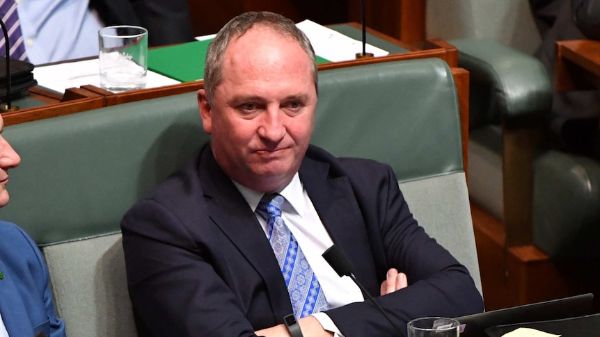 Barnaby Joyce sitting in the House of Representatives with his arms crossed.