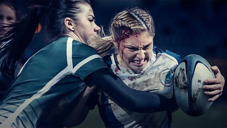 A woman with a cut to her head plays rugby in the new Bodyform ad.