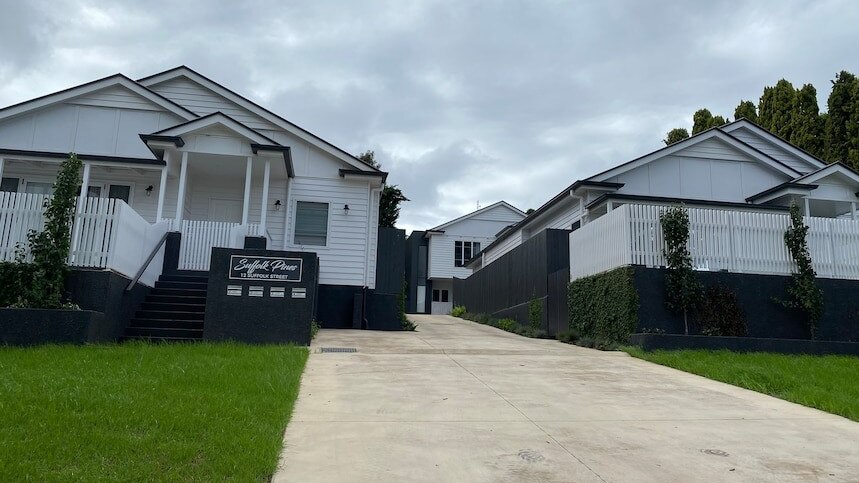 Two newly-built homes sitting side by side in one of Toowoomba's newest housing estates.