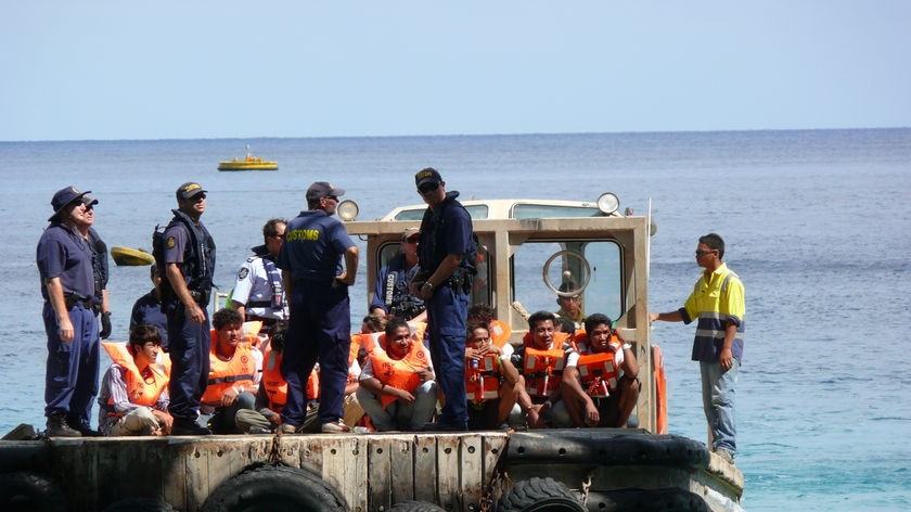 A boat-load of possible asylum seekers is transferred to Christmas Island