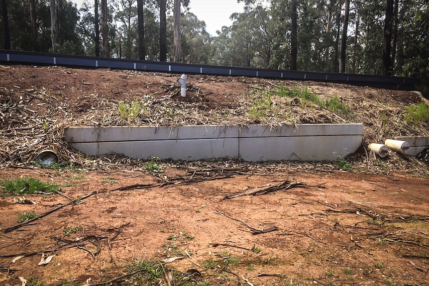 The house is partially underground with a 45 degree angled slope built for fire resilience.