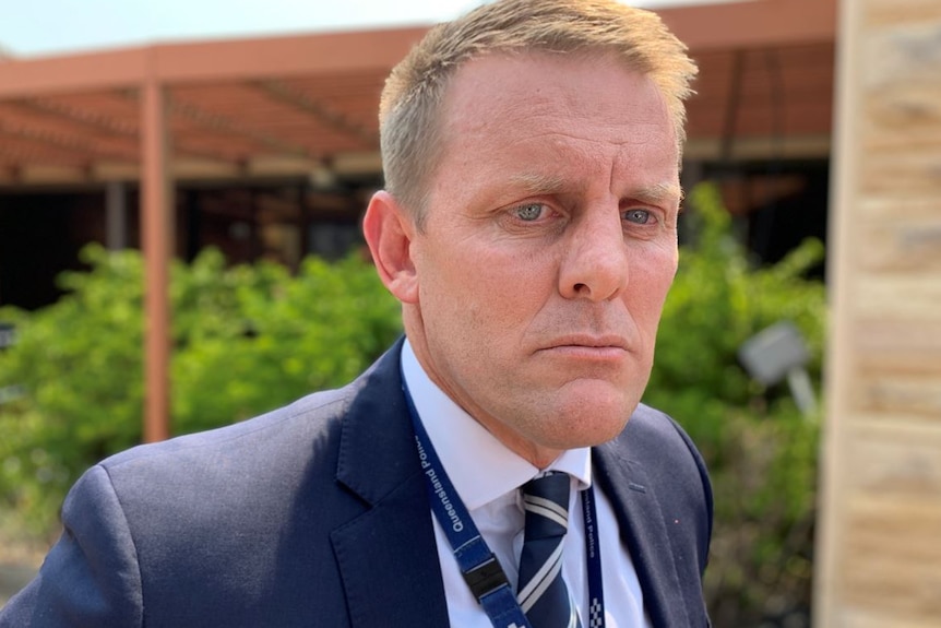 A blonde man with a concerned expression wearing a suit jacket, shirt and tie