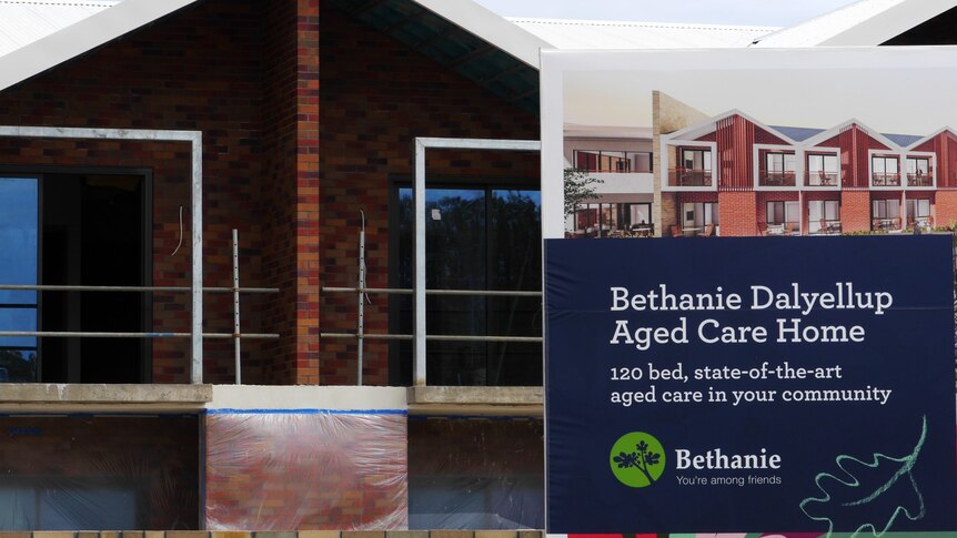 A house under construction with a billboard outside saying Bethanie Dalyellup Aged Care Home.