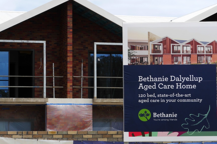 A house under construction with a billboard outside saying Bethanie Dalyellup Aged Care Home.