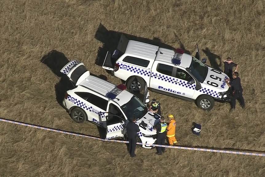 Police cars at a crash site.