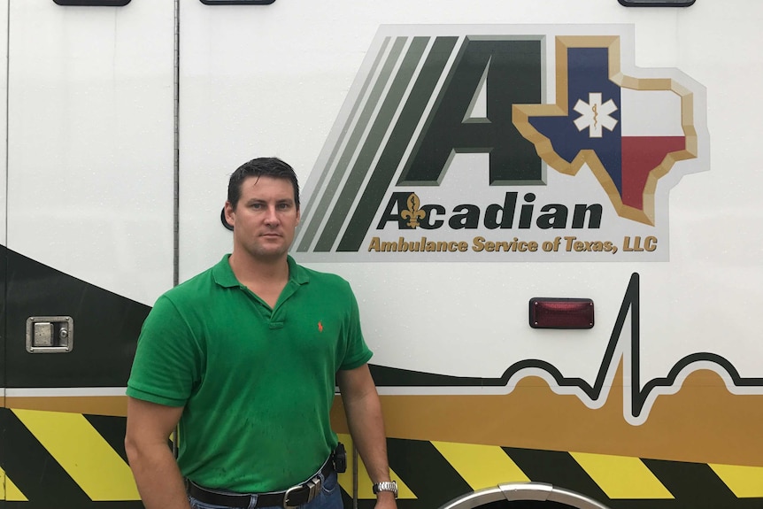 A man stands in front of an ambulance in Texas