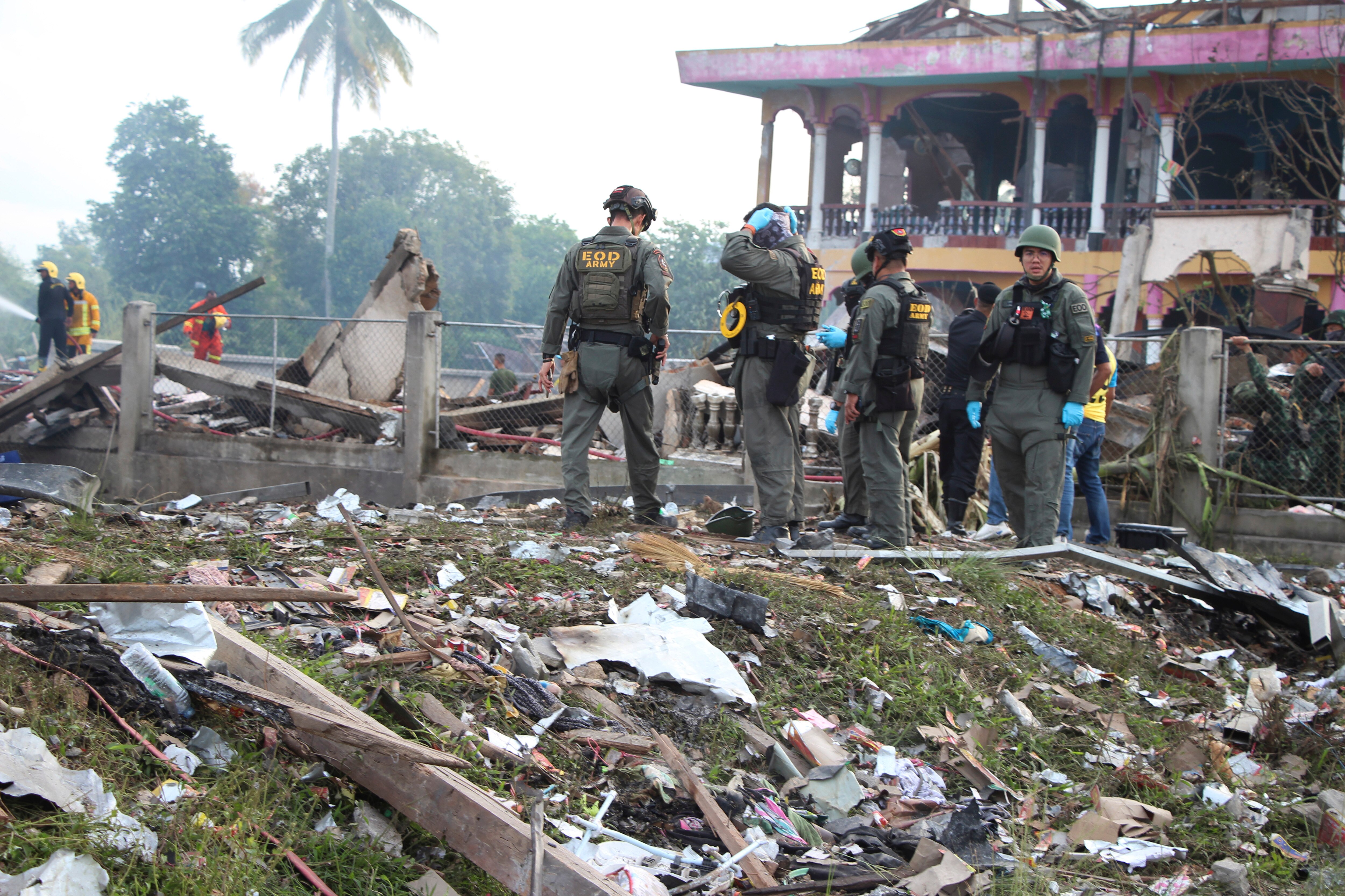 People at the site of an explosion at a Thai firework warehouse.